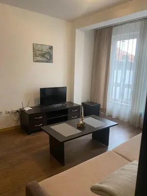 a living room with a couch and a coffee table at Bansko Royal Towers Apartment - top location in Bansko