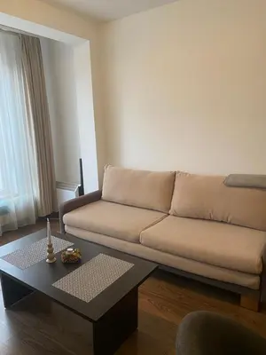 a living room with a couch and a coffee table at Bansko Royal Towers Apartment - top location in Bansko