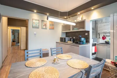 a kitchen and dining room with a table and chairs at Megan apartment Sofia Mall center in Sofia