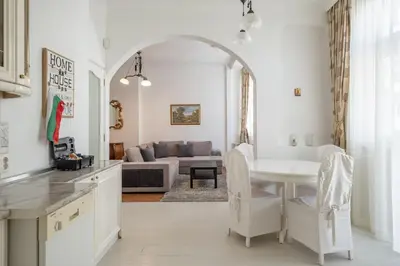 a kitchen and living room with a table and a couch at Aristocratic Elegant 2 BDRM spacious home TOP CENTER in Sofia