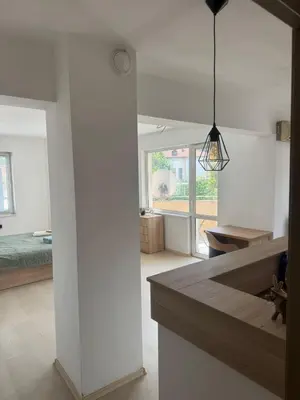 a kitchen and living room with white walls at Апартамент за гости ''ЗДРАВЕ'' in Kyustendil