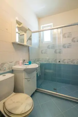 a bathroom with a toilet and a glass shower at Very Central & Aristocratic 2 Bedroom Apartment with Air conditioning in Sofia