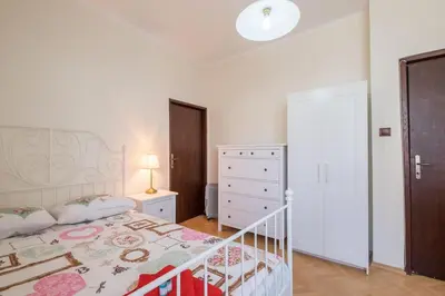 a white bedroom with a bed and a dresser and a drawer at Very Central & Aristocratic 2 Bedroom Apartment with Air conditioning in Sofia