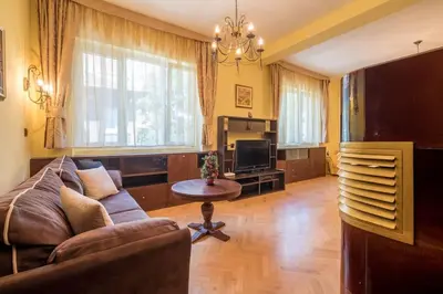 a living room with a couch and a tv at Very Central & Aristocratic 2 Bedroom Apartment with Air conditioning in Sofia