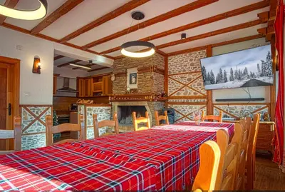 a dining room with a table with a checkered table cloth at Villa Martina in Smilyan