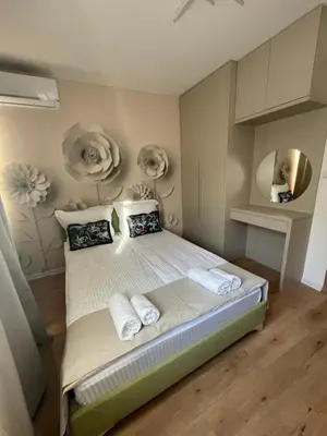 a bedroom with a bed with towels on it at Apartment Park View in Sandanski