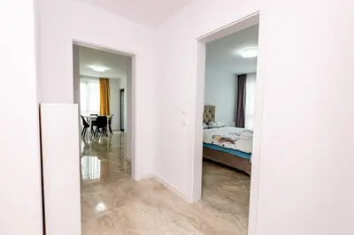 a white room with a bed and a dining room at Apartment Golden Park in Sandanski