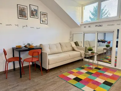 a living room with a couch and a table at Comfy Studio by Cosher in Sofia
