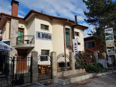 a small white building with a sign on it at D Villa in Mineralni Bani