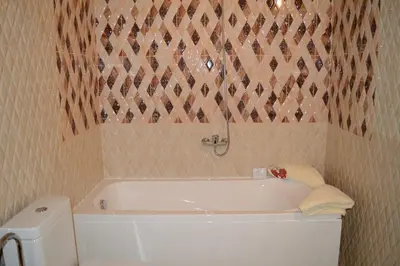 a bathroom with a white tub and a toilet at D Villa in Mineralni Bani