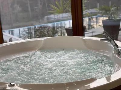 a bath tub filled with water in a window at D Villa in Mineralni Bani