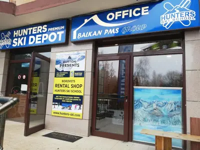 a store front of a ski depot with signs on it at Sunny two bedroom apartment 12 in Tulip , Flora Residence - prime location! in Borovets