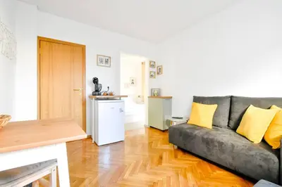 a living room with a gray couch and yellow pillows at Central Duplex Wi-Fi, Kitchen, Netflix, Heating in Sofia