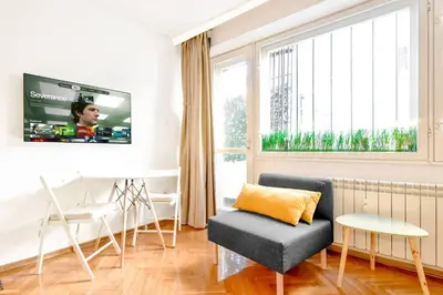 a living room with a couch and a tv at Central Duplex Wi-Fi, Kitchen, Netflix, Heating in Sofia