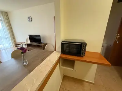 a microwave sitting on a counter in a room at Apartment for 6 in Flora main building - prime location! in Borovets