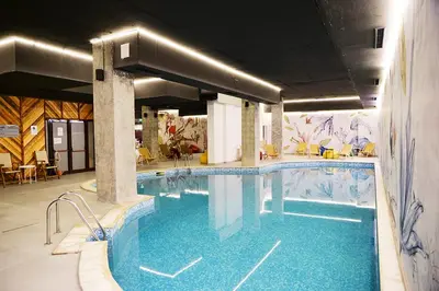 a large swimming pool with blue water in a building at Apartment for 6 in Flora main building - prime location! in Borovets