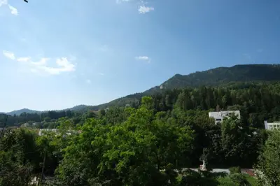 a view of a mountain with trees and buildings at Апартамент за гости Симона in Smolyan