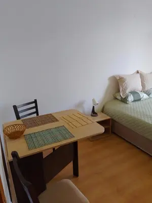 a room with a desk and a bed and a table at Студио 36 - Семирамида, Боровец in Borovets