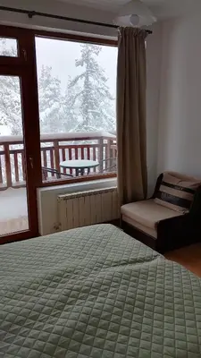 a bedroom with a bed and a window with a view at Студио 36 - Семирамида, Боровец in Borovets