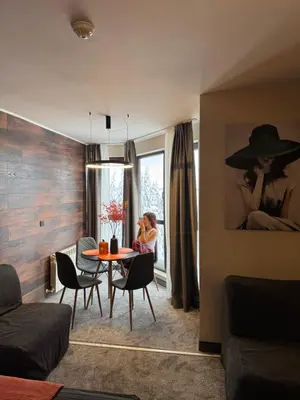 a child sitting at a table in a living room at Passion & Sense Studios Pamporovo in Pamporovo