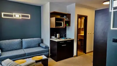 a living room with a couch and a table at Passion & Sense Studios Pamporovo in Pamporovo