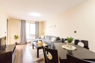 a living room with a couch and a table at Liftside Alpine Suite in Bansko