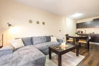 a living room with a couch and a table at Liftside Alpine Suite in Bansko