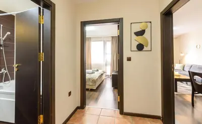 a bathroom with a door leading to a bedroom at Liftside Alpine Suite in Bansko