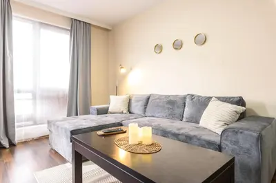 a living room with a couch and a table at Liftside Alpine Suite in Bansko
