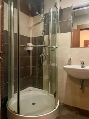 a bathroom with a glass shower and a sink at Mountain view 1-bedroom apartment few steps from ski piste and Gondola lift in Bansko