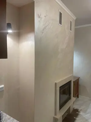 a living room with a fireplace in the wall at English Apartments 2 in Bansko