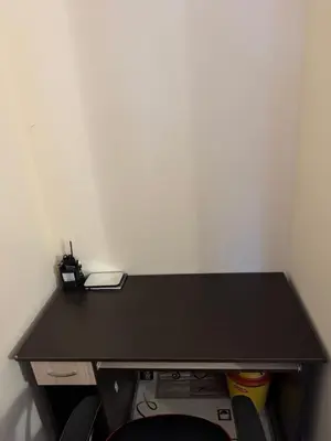 a black desk in a corner of a room at Mimsi Apartment in Pamporovo