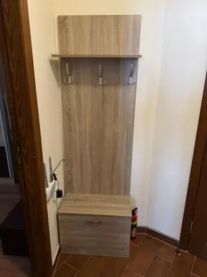 a wooden box in a room with a door at Mimsi Apartment in Pamporovo