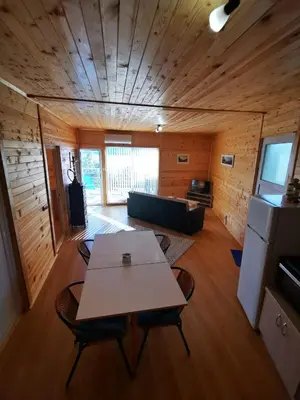 a room with a table and chairs in a cabin at Lakeview Estate Chalet in Staro Myasto