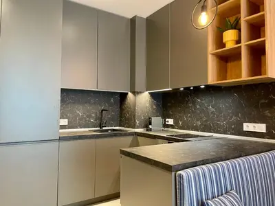 a kitchen with white cabinets and a sink at Apartment with Free Underground Parking by COSHER in Sofia