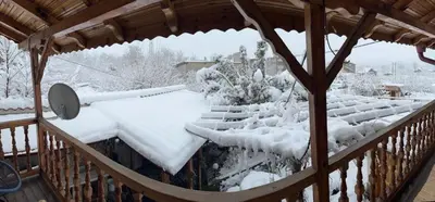 a balcony covered in snow on a house at Villa Popovi in Simitli