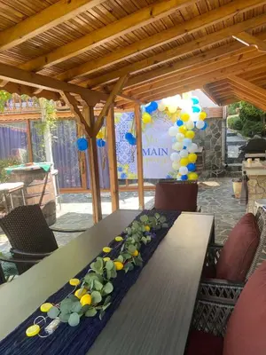 a table with a garland of fruits and balloons on it at Villa Popovi in Simitli