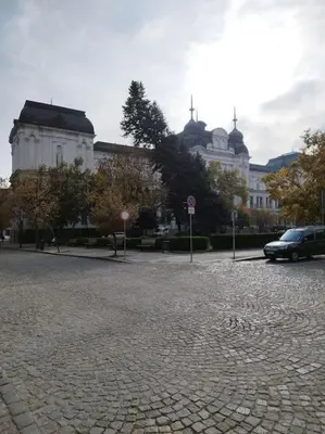 a car parked on a brick road in front of a building at The Cathedral in Sofia