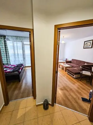 a living room with a couch and a living room with a mirror at Mountain Dream A8 apartment in Borovets