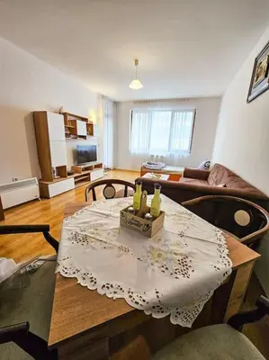 a living room with a table and a couch at Mountain Dream A8 apartment in Borovets