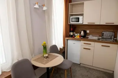 a small kitchen with a table and chairs in a room at BG Hotel in Sofia