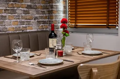 a table with a bottle of wine and glasses at BG Hotel in Sofia