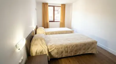 two beds in a small room with a window at Mountain Paradise 2 - Cosy 2 Bed Mountain View Apartment - Washer in Bansko