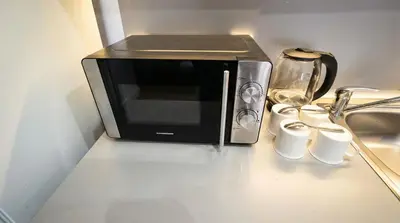a microwave sitting on top of a kitchen counter at Mountain Paradise 2 - Cosy 2 Bed Mountain View Apartment - Washer in Bansko