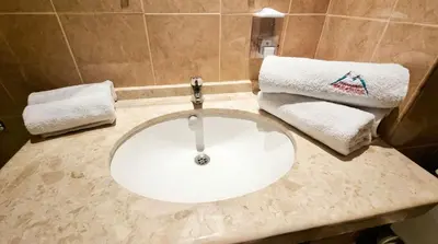 a bathroom with a sink and towels on a counter at Mountain Paradise 2 - Cosy 2 Bed Mountain View Apartment - Washer in Bansko