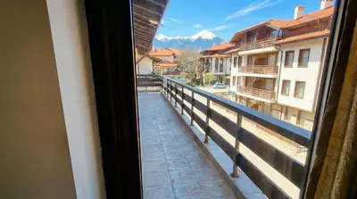 a view from a window of a street with a mountain at Mountain Paradise 2 - Cosy 2 Bed Mountain View Apartment - Washer in Bansko