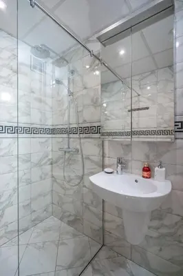 a bathroom with a sink and a glass shower at Green Haven in Sofia