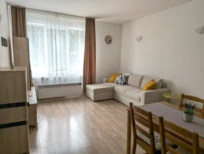 a living room with a couch and a table at STRIM Apartment 406 Stream Resort, Pamporovo in Pamporovo