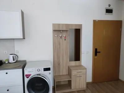 a laundry room with a washing machine and a washer at STRIM Apartment 406 Stream Resort, Pamporovo in Pamporovo