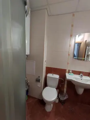 a bathroom with a toilet and a sink at STRIM Apartment 406 Stream Resort, Pamporovo in Pamporovo